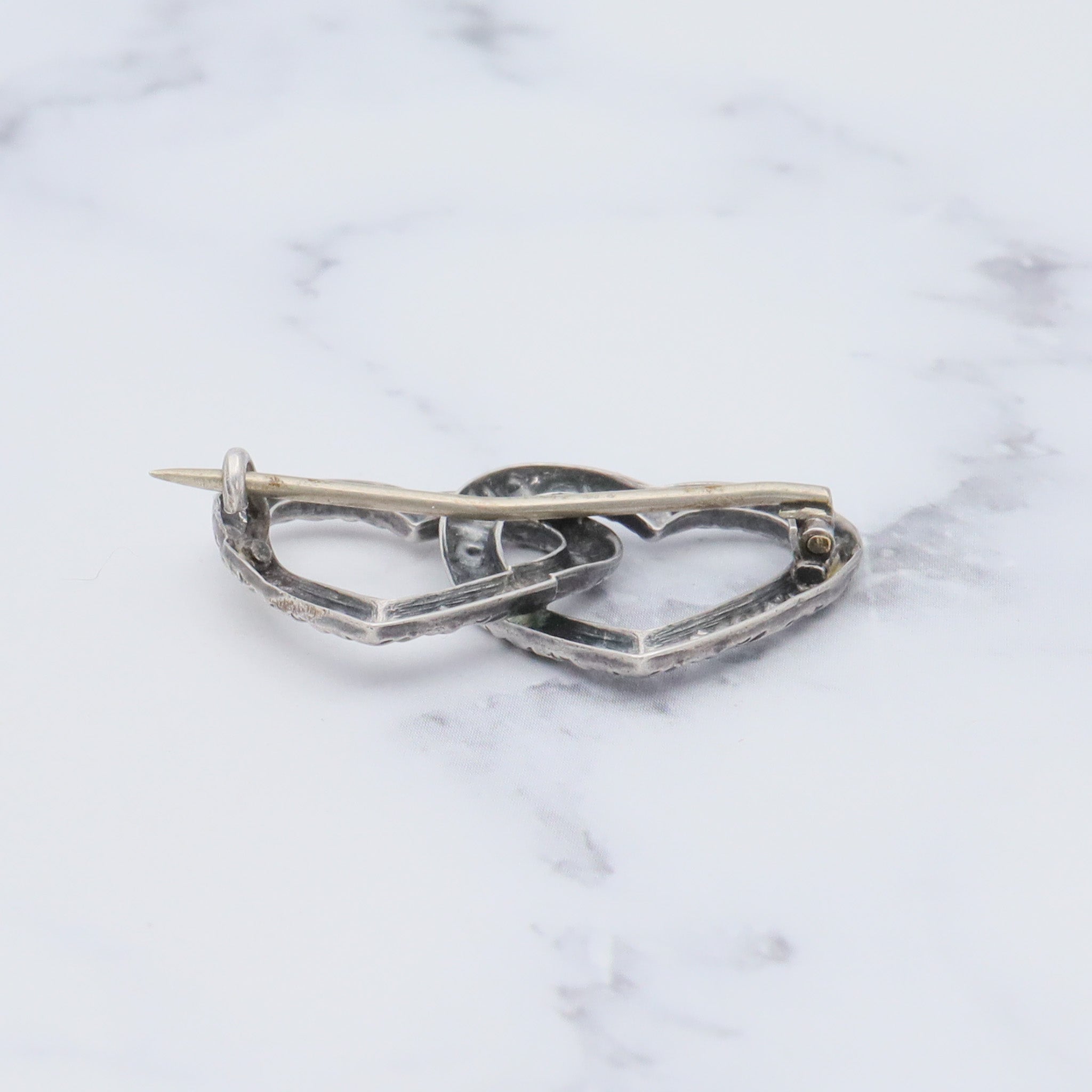 Antique Victorian sterling repousse double heart brooch